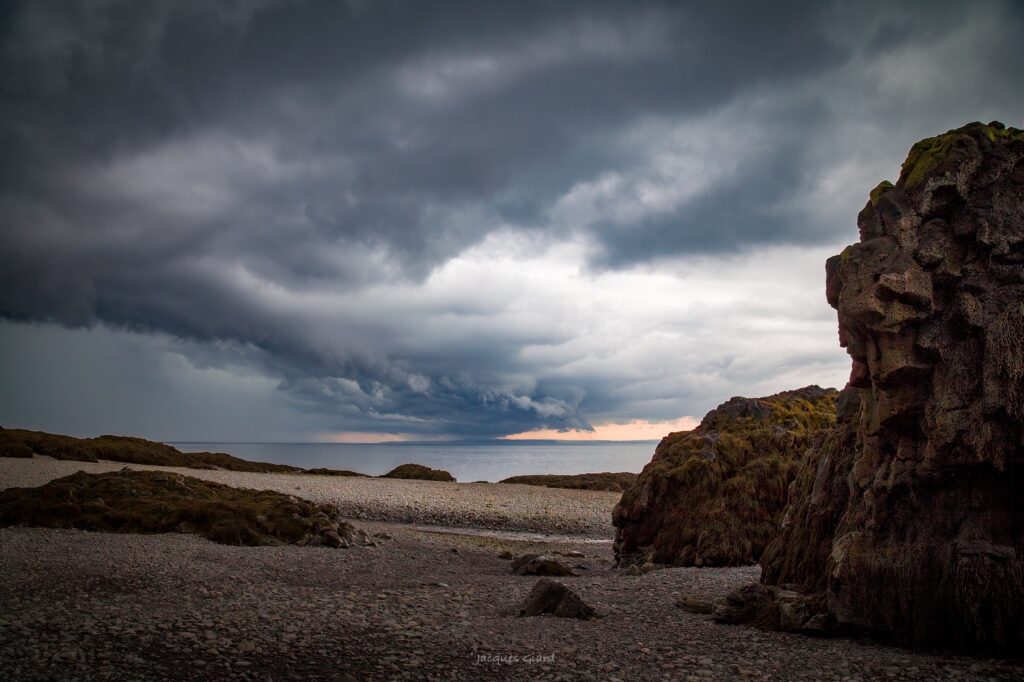 Dramatic storm clouds gathering over the beach at Baxter's Harbour on the Bay of Fundy.